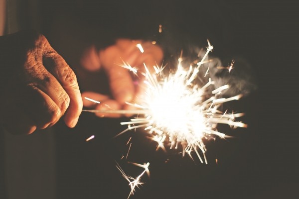 hands holding sparklers