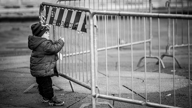 child standing at fence
